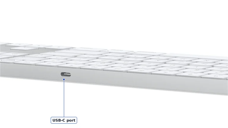 Back edge of the white Magic Keyboard with Touch ID and Numeric Keypad with the USB-C charging port in the aluminium frame, labelled USB-C port