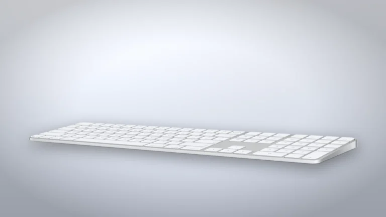 White Magic Keyboard with Touch ID and Numeric Keypad at an angle, showing the full width with the navigation keys, the inverted-T arrow keys and the numeric pad