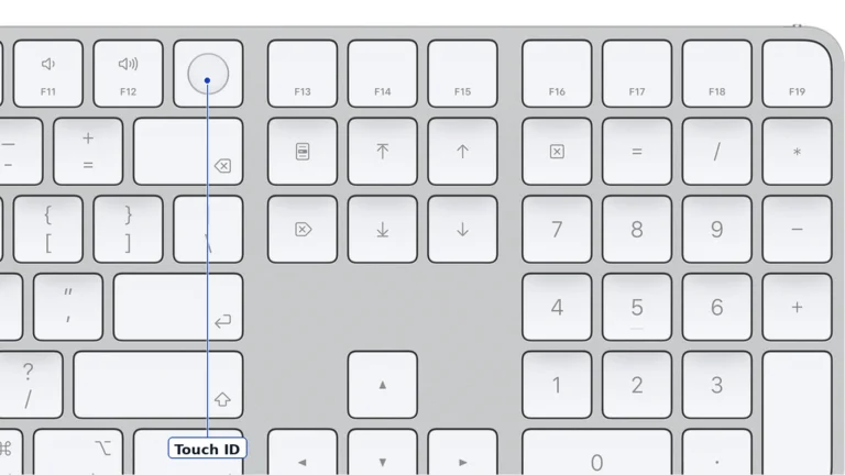 Close view of the white Magic Keyboard with Touch ID and Numeric Keypad showing the round Touch ID key after F11 and F12, the F13 to F19 keys, the navigation keys with symbol labels and the numeric pad, with a Touch ID label