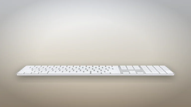 White Magic Keyboard with Touch ID and Numeric Keypad seen from the front at a low angle, showing its thin wedge profile on a neutral backdrop