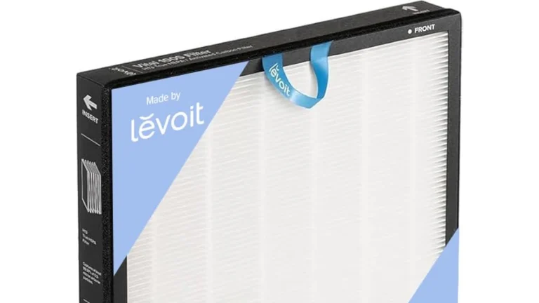 Upper half of the Levoit Vital 100S replacement filter, showing the pleated white particle media, the black frame with a front marking and the blue ribbon pull tab