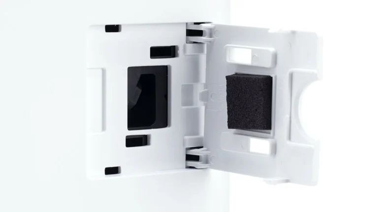 Side hatch of the Levoit Vital 100S-P opened to show the dust sensor window and the black foam pad fixed inside the cover