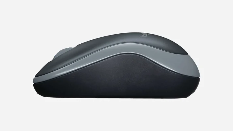 Logitech M185 photographed from the side at desk level, showing the low 39 mm profile and the curve of the shell from front to back