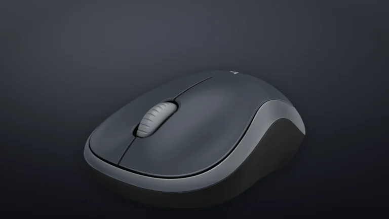 Logitech M185 in Swift Grey seen from a front three-quarter angle against a dark background, showing the two main buttons and the grey side panels