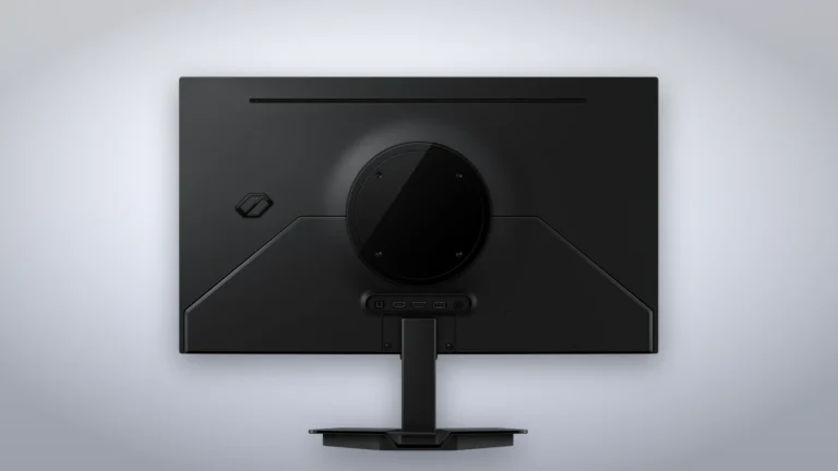 Back of the black Samsung Odyssey OLED G5 G50SF showing the round stand mount, the port bar and the flat base on a grey studio backdrop
